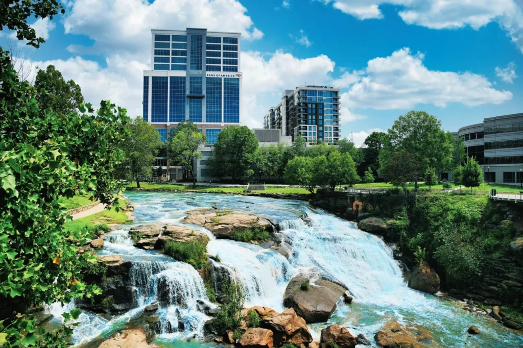 Scenic view highlighting Greenville's urban waterfall, promoting luxury travel with VOY.