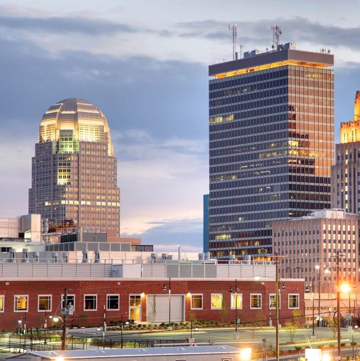 Charlotte-bound luxury car service departing Winston-Salem at sunset.